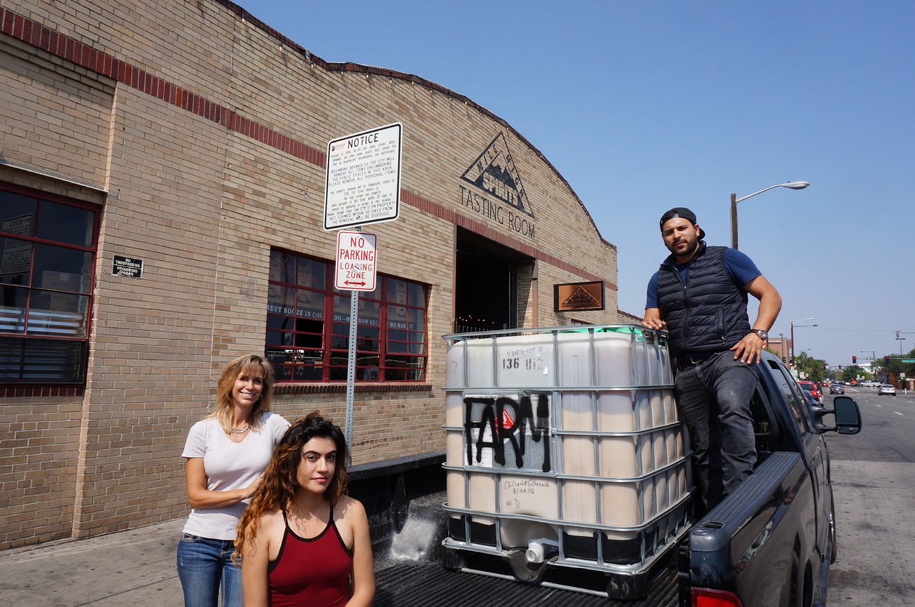 Deborah Vallin (left), Cynthia Sanchez and Jose Gonzalez meet at Mile High Spirits to pick up spent corn mash that will be fed to Vallin's cattle.