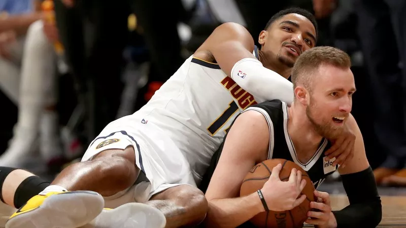 Image: The Denver Nuggets' Gary Harris lands on the Brooklyn Nets' Dzaanan Musa during a recent game that wasn't seen on Comcast.