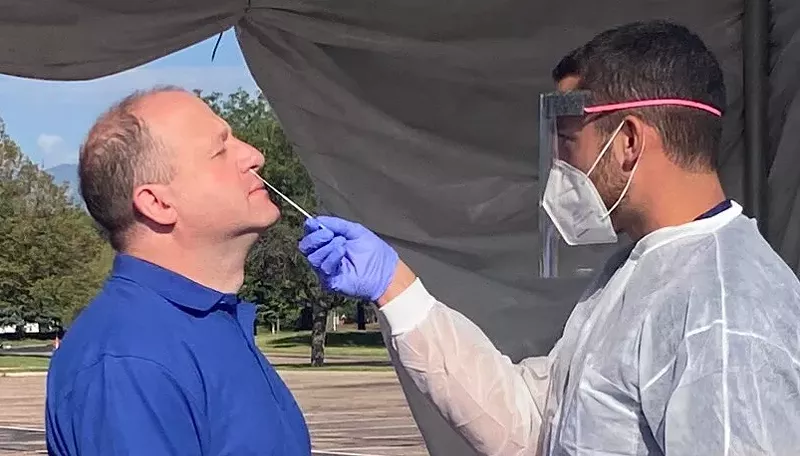 Image: Governor Jared Polis getting tested for COVID-19 at Colorado Springs' Citadel Mall earlier this year.