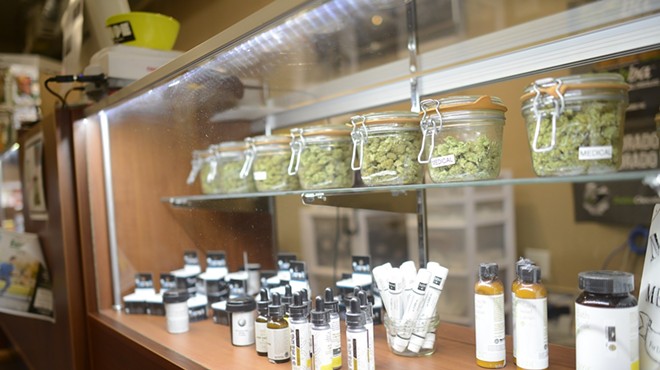 Medical marijuana product counter filled with weed jars and pre-rolled joints