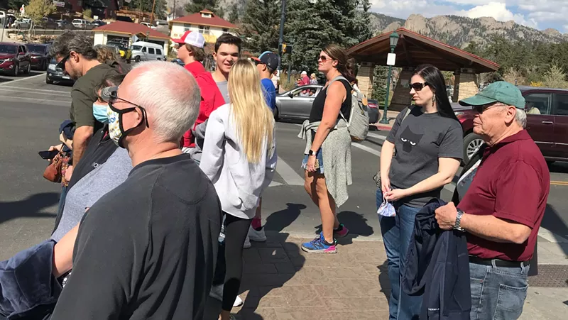 Image: A majority of folks gathered at this Estes Park crosswalk were unmasked.