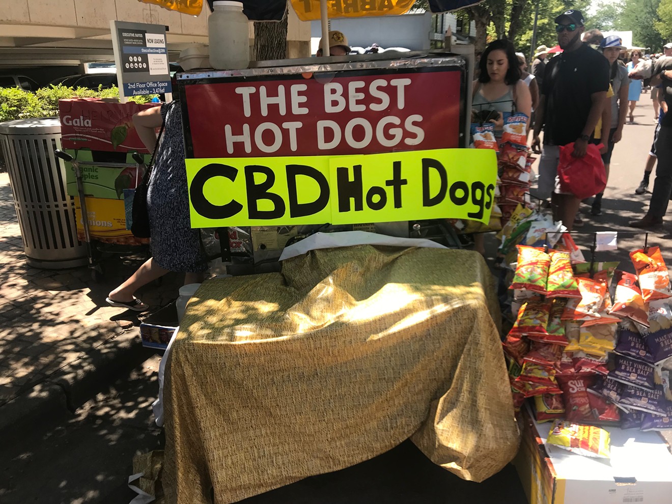 A hot dog vendor offers a CBD topping during the Cherry Creek Arts Festival,