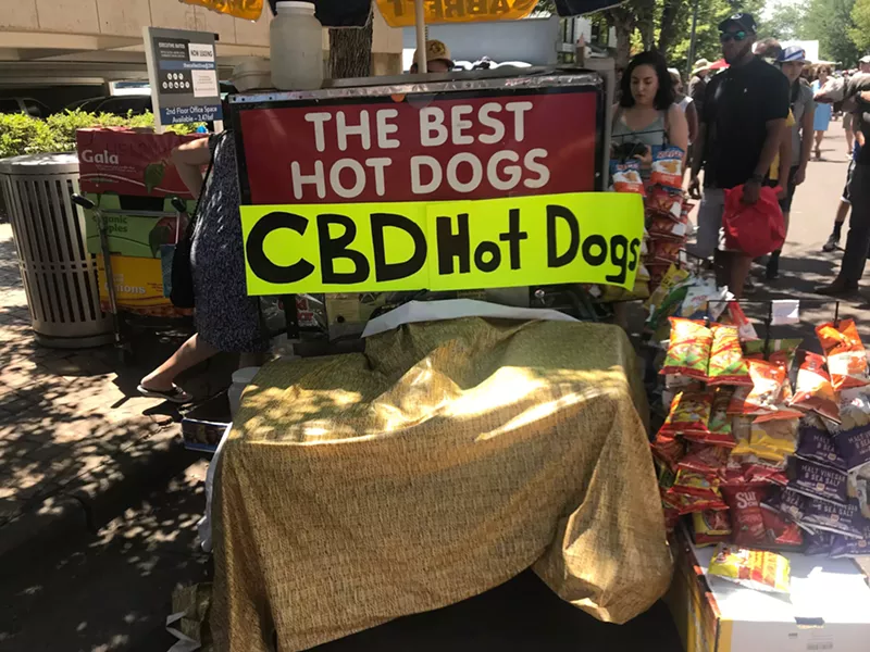 Image: A hot dog vendor offers a CBD topping during the Cherry Creek Arts Festival,