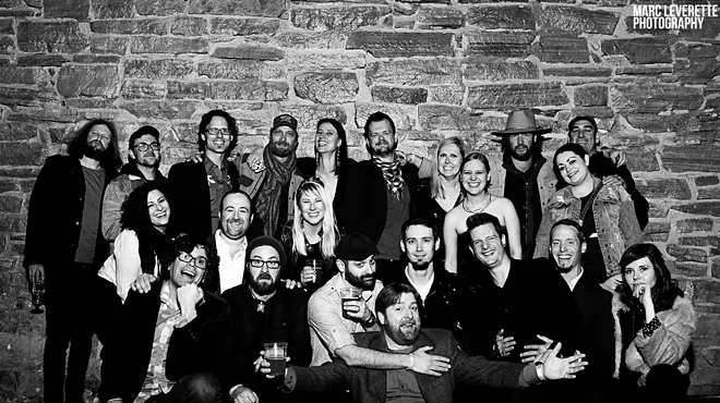 a lot of people smile for a group photo at the FoCo Peer Awards