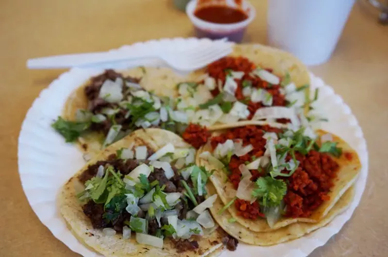 Image: The best taquerias keep it simple, like these chorizo and lengua tacos at Taco Mex — just meat, onions and cilantro.