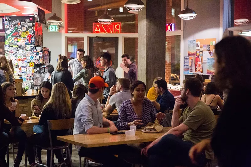 Image: people sitting at tables inside a restaurant