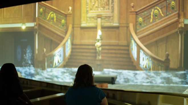 A person watches as water floods the great hall of the Titanic