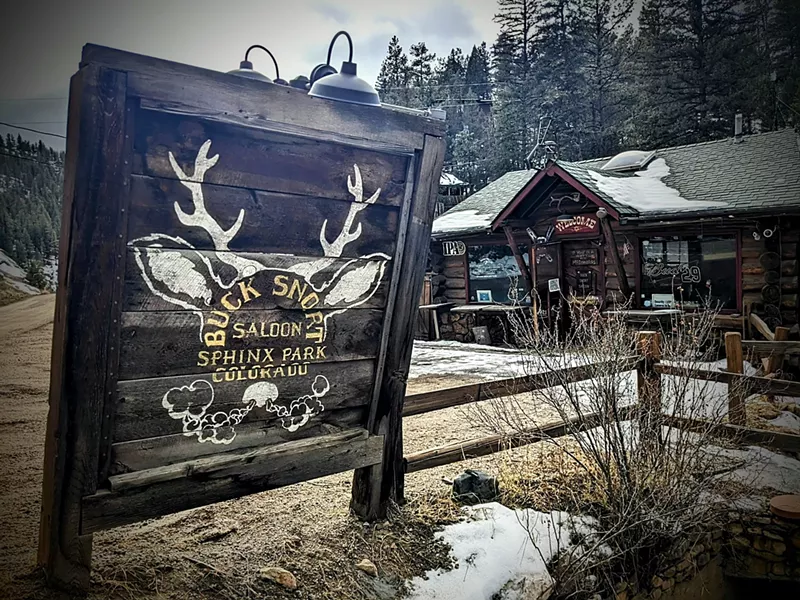 Image: rustic sign outside of a wooden building
