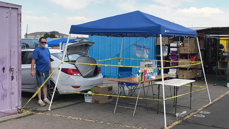 Image: Yes, it's a man selling masks at Mile High Flea Market who's not wearing a mask.