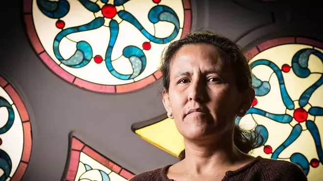 woman in front of stained glass.