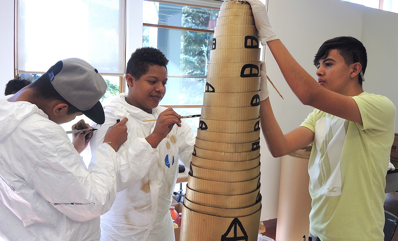Jeyson (left), Alexander and Gabriel use cardboard to create a skyscraper, which will be placed in the center of the gallery.