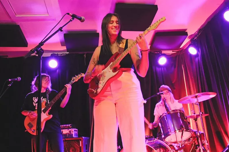 Image: woman playing guitar