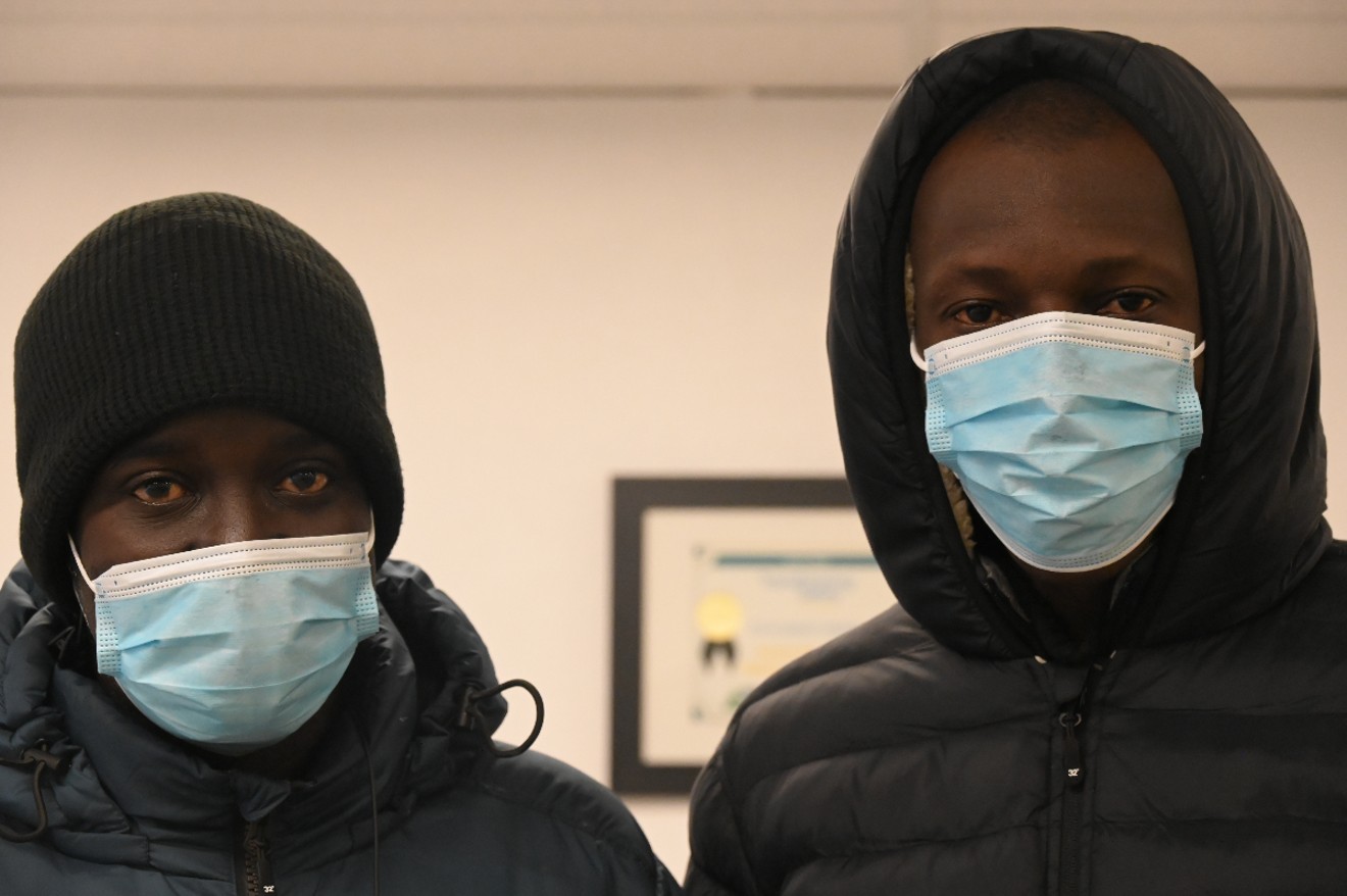 Aboubacrine Cisse and Yoas Diab from Mauritania stand inside the Dayton Day Labor Center.
