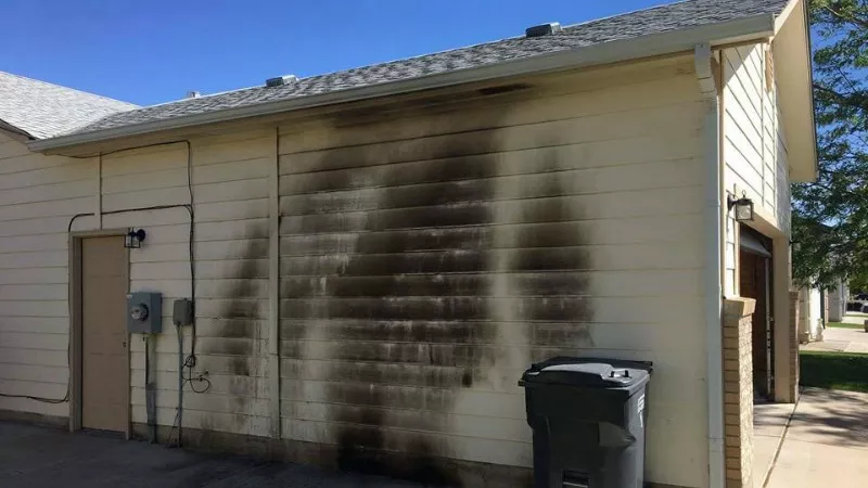 Image: A scorched wall at the former home of Donthe Lucas, a suspect in the disappearance of Kelsie Schelling.
