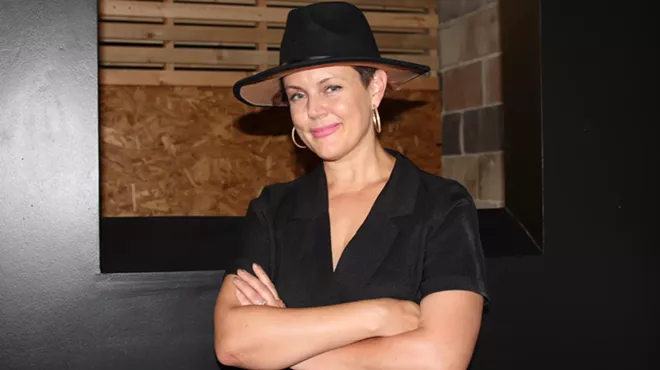 A woman poses in a building.