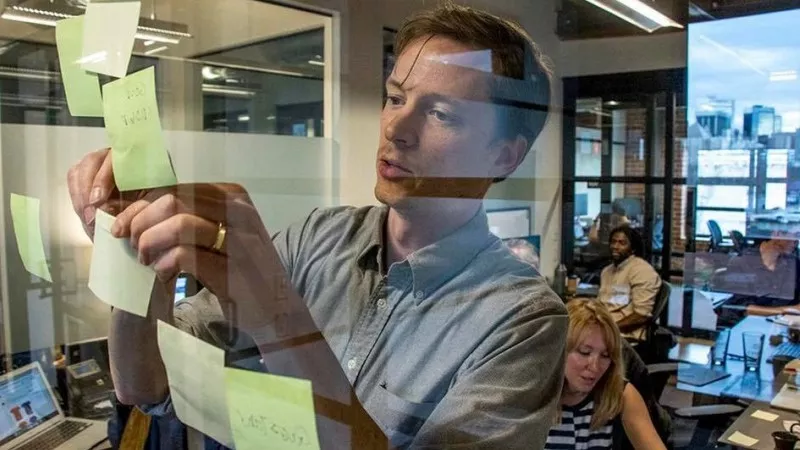Image: Denverite founder and editior Dave Burdick at work in a photo shared in a Colorado Media Project release announcing the deal.