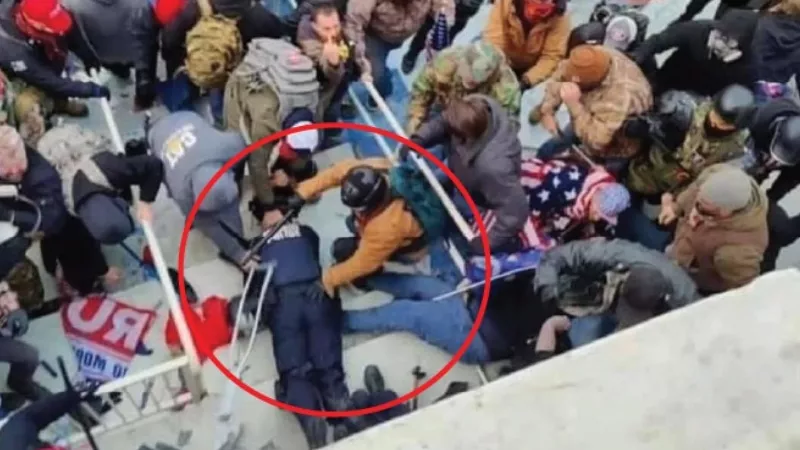 Image: Prosecutors contend that Jeffrey Sabol is the man wearing the tan jacket and green backpack in the circled area who helped drag a police officer down a flight of stairs.