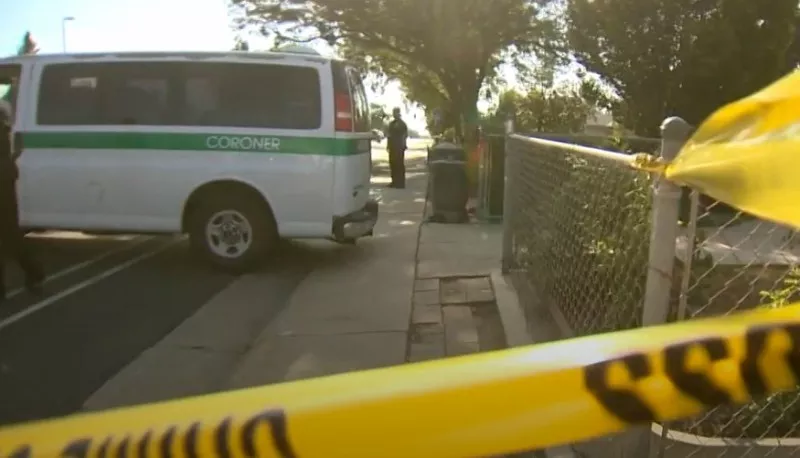 Image: A coroner's van outside the Black residence the morning after the shooting.