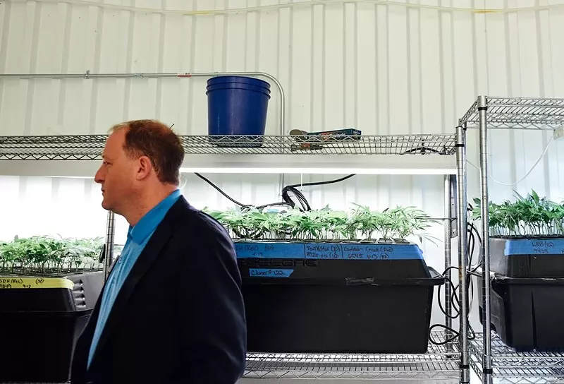 Image: Governor Jared Polis tours a marijuana growing operation in 2018.