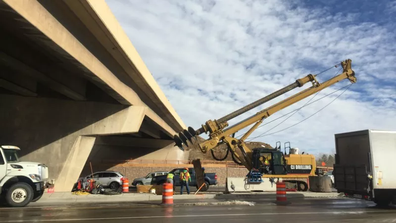 Image: A drill rig beneath the Broadway bridge circa December 2017. This photo is part of a large gallery documenting the project of the C-470 Express Lanes project.