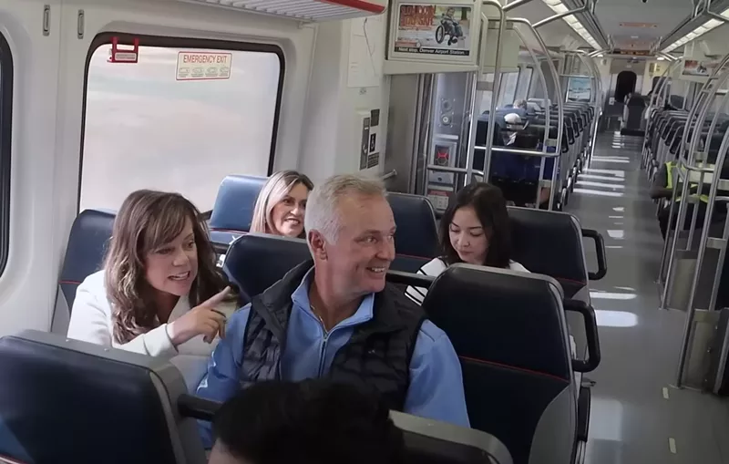 Image: People sit on a train