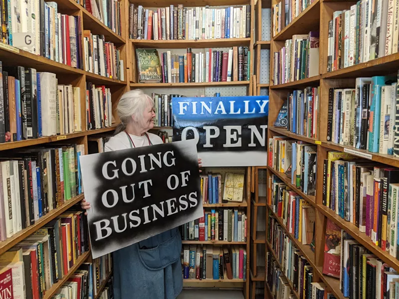 Image: Holly Brooks isn't sure which sign Capitol Hill Books will be hanging.