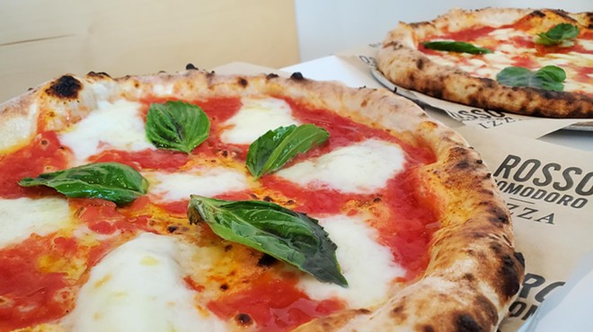 a pizza with tomato sauce, mozzarella and basil