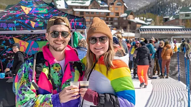 man and woman in ski clothes with beer