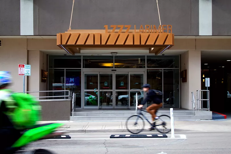 Image: A bicyclist riding by the Windsor Condos at 1777 Larimer Street.