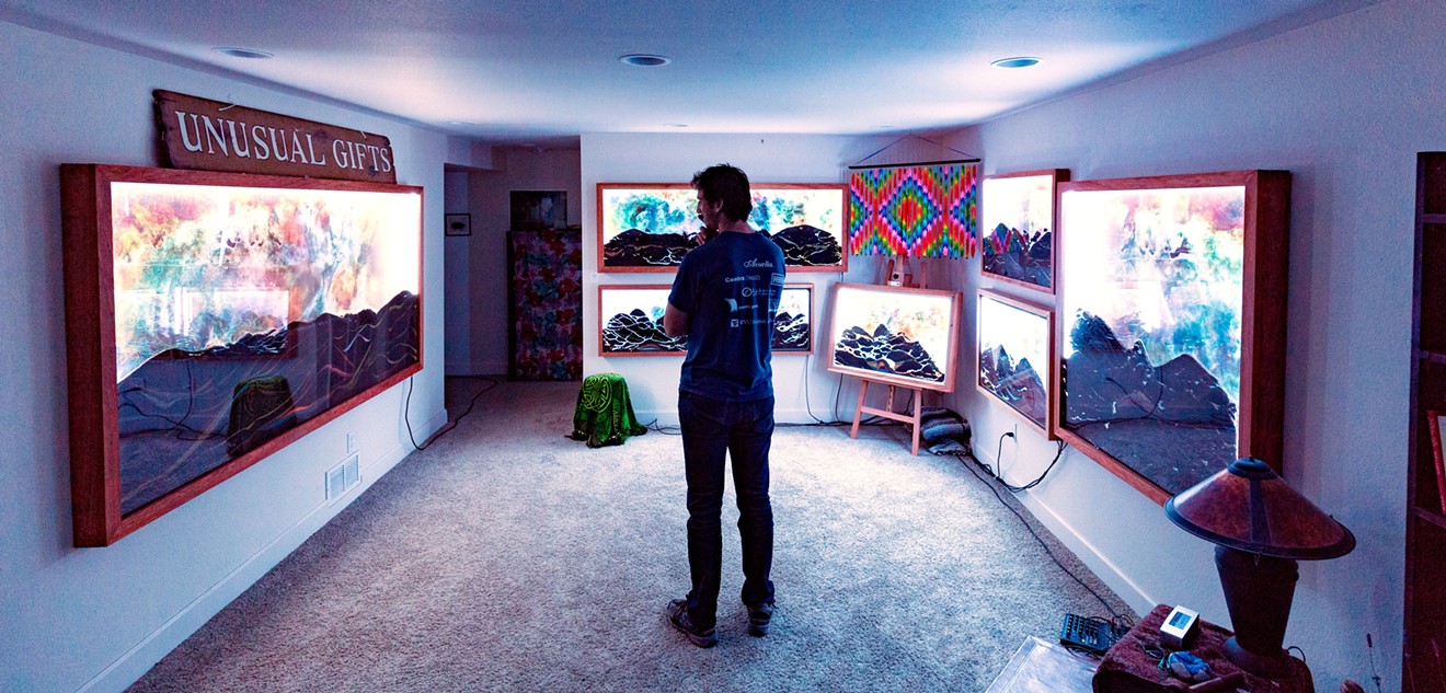 Engineer-biker-artist Jacob Lemanski surrounded by his Ant Space art in his Boulder basement gallery.