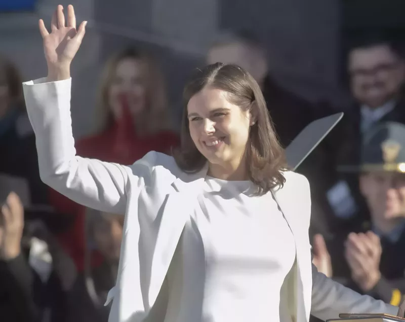 Image: woman in white waving