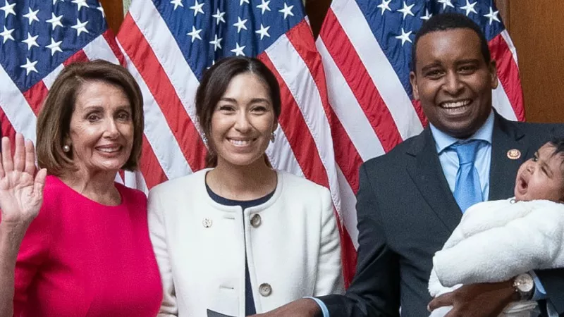 Image: U.S. Speaker of the House Nancy Pelosi swearing in Colorado Representative Joe Neguse, accompanied by wife Andrea and daughter Natalie, in January.