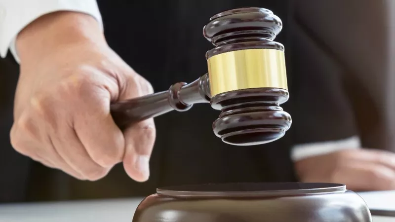 Image: gavel in hand.