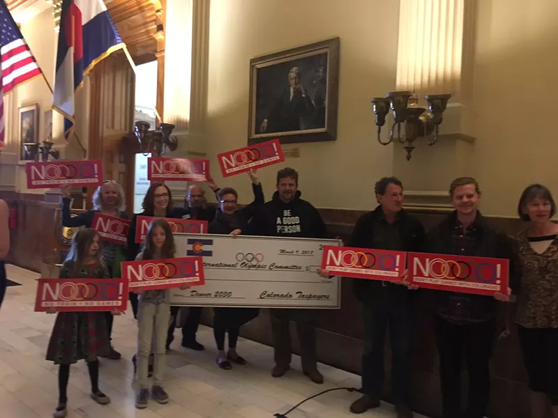 Image: NOlympics supporters under Governor Richard Lamm's portrait at the Capitol.