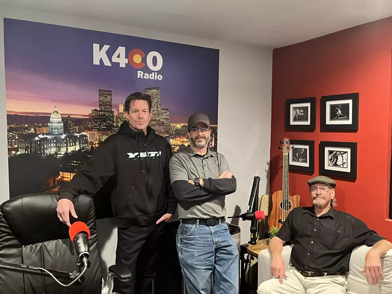 Image: three men standing in a radio room