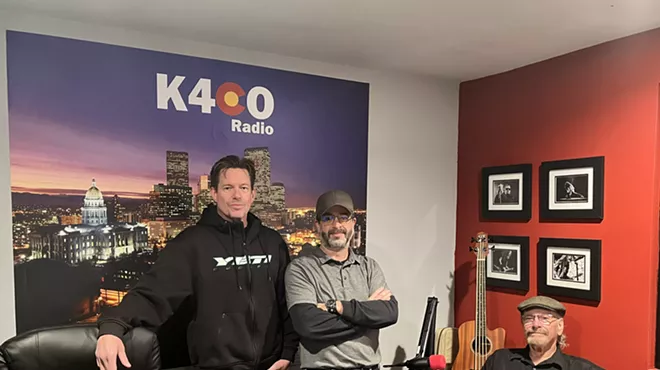 three men standing in a radio room