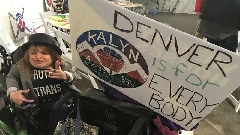 Image: Kalyn Heffernan with ADAPT activist Robin Stephens (behind sign).