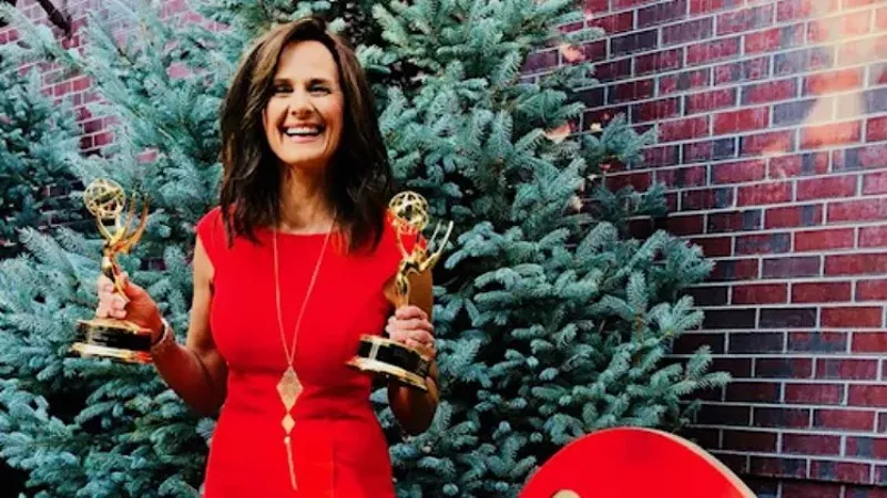 Image: 9News forecaster Kathy Sabine with two of her most recent Emmy awards.