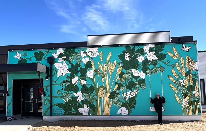 Image: Kelsey Montague interacts with her mural at Danico Brewing.