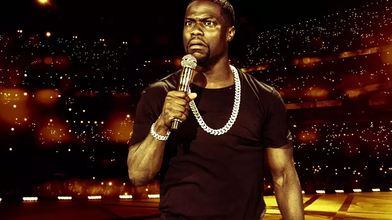 Image: man wearing a diamond chain necklace holding a microphone