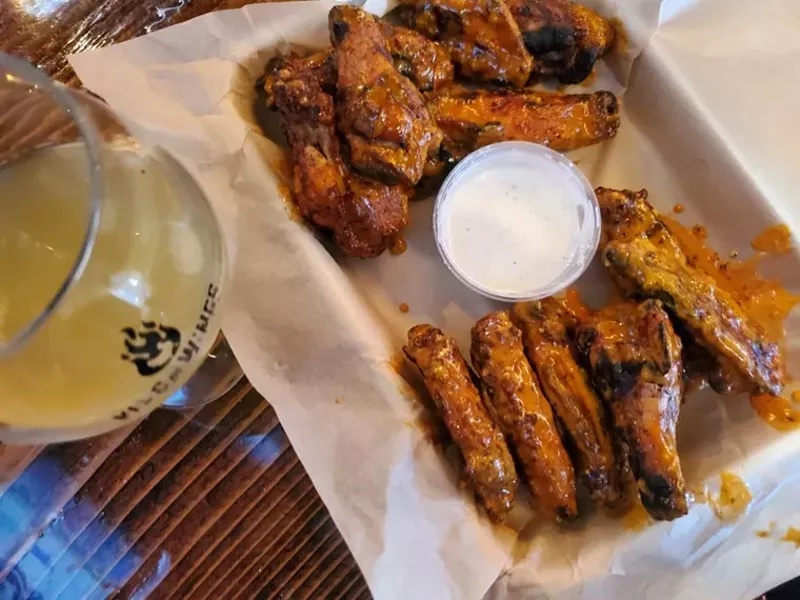 Image: chicken wings and a side of ranch on a tray