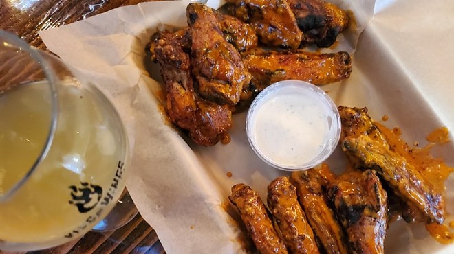 chicken wings and a side of ranch on a tray