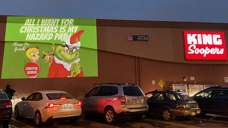 A protest projection on a Denver area King Soopers store on December 14.