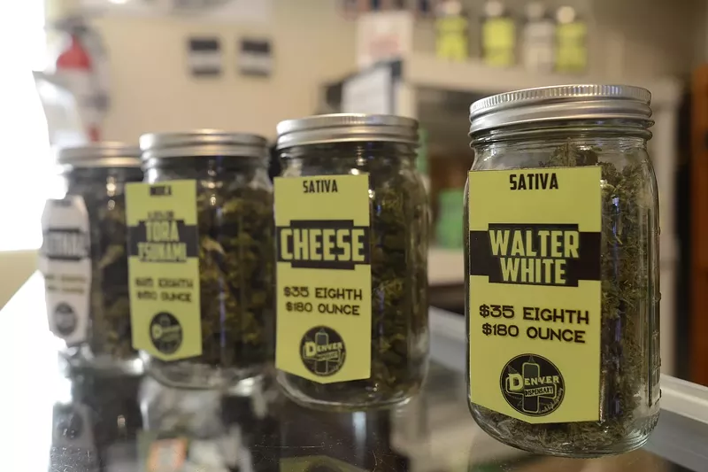 Image: Jars of cannabis flower for sale inside a Denver dispensary