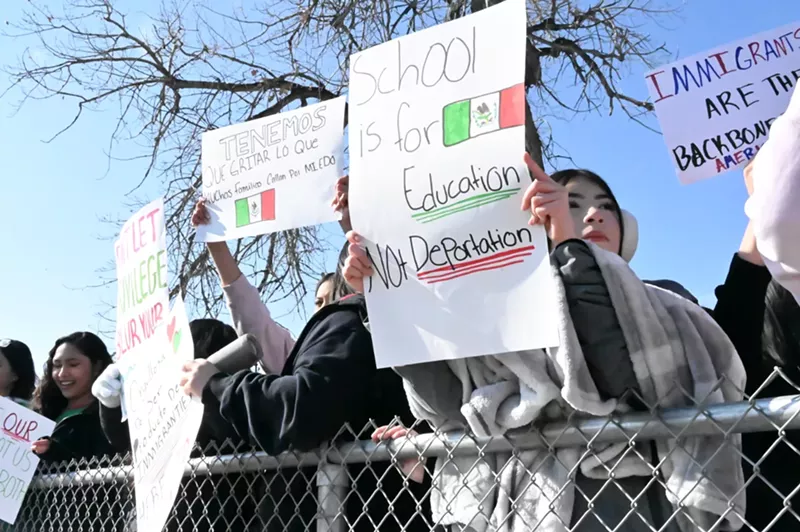 Image: Teenage protesters hold up a sign.