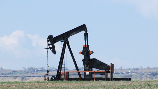 Oil well sits in front of blue sky