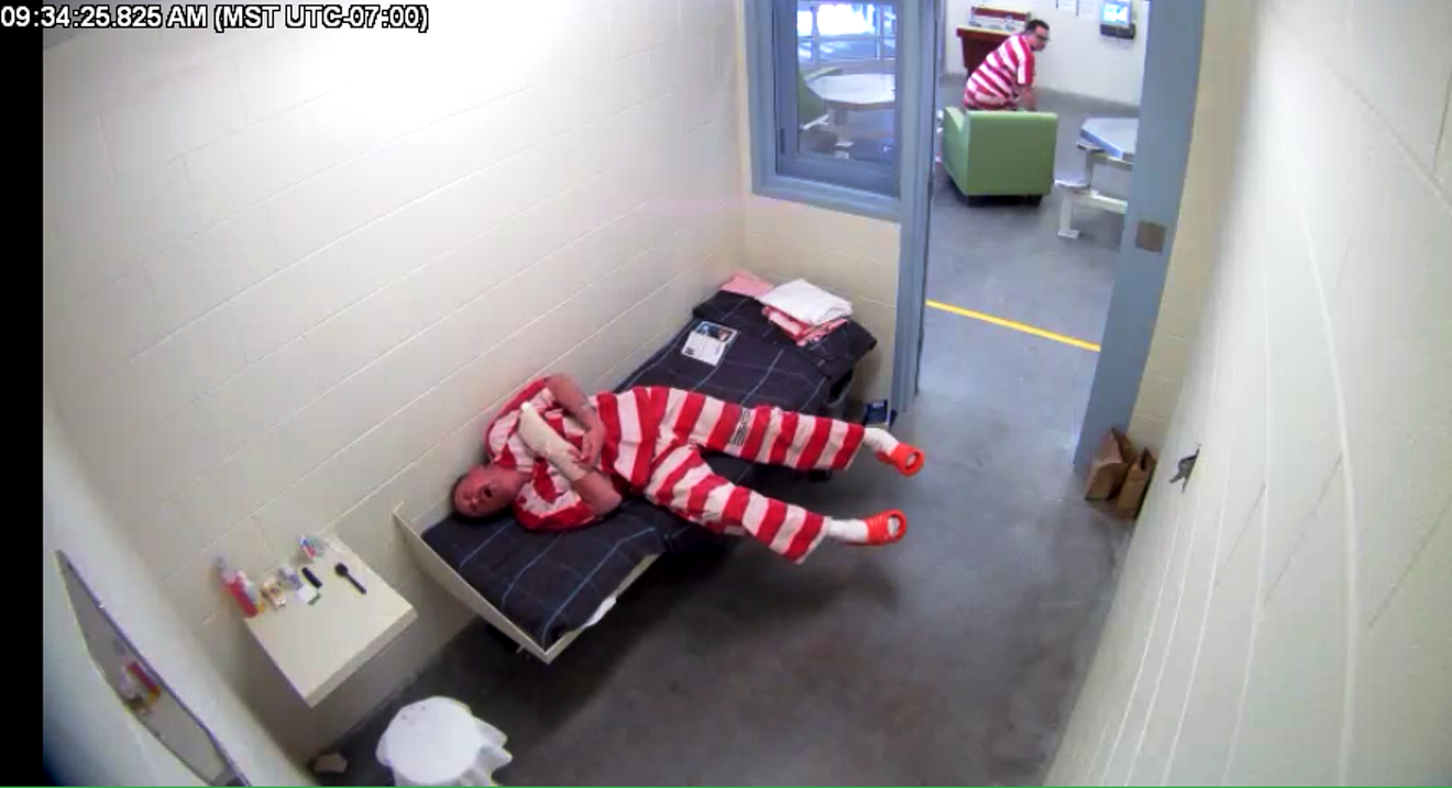 A screen capture from surveillance footage shows Kevin Hartwell having a seizure in his cell  on November 29, 2016, while an inmate in the day room rises to summon help.
