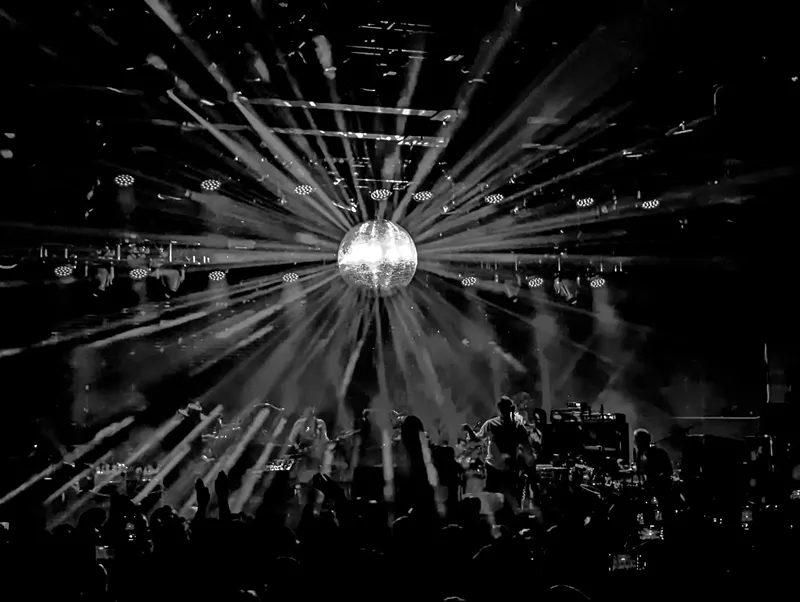 Image: a star-like burst of electric lights on stage
