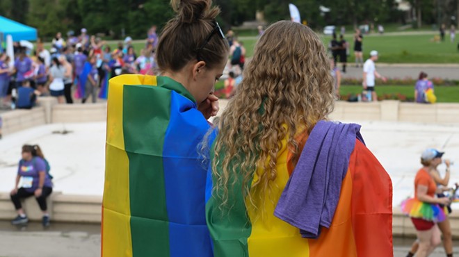 two people in Pride flag