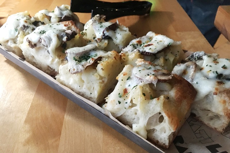 Liberati adds Roman-style pizza, including this one topped with potatoes, cheese, mushrooms and black truffle pâté, to its menu.